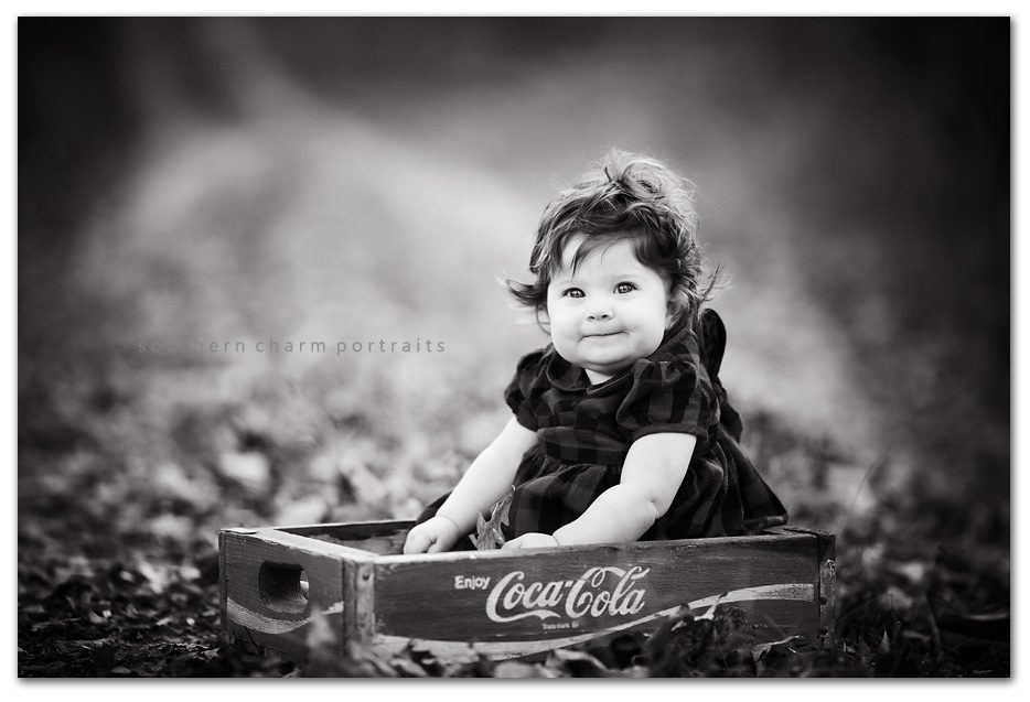black and white digital image six month old baby in coke cola box