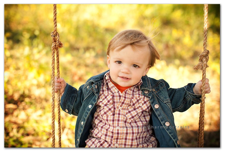 sweet brown eyed little brother boone in tree swing with denim jacket and layers of fall clothing