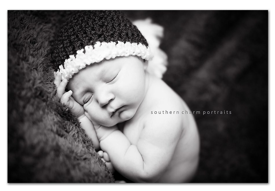 newborn sleeping baby with christmas hat in black and white