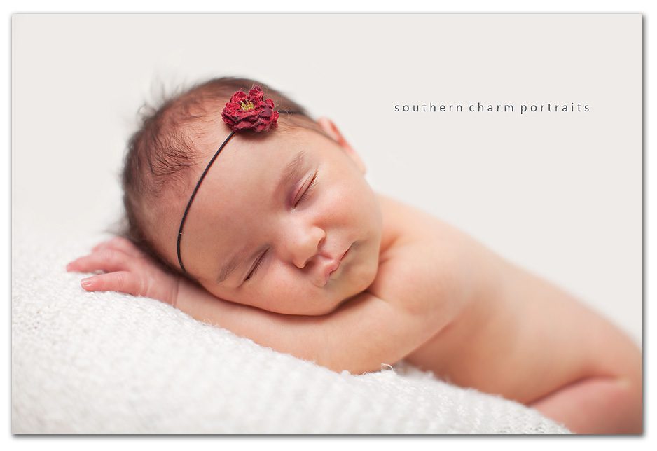 sweet sleeping newborn naked with rose head band