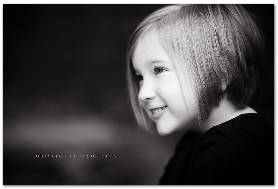 I think this is a really sweet profile shot of a little girl smiling in black and white