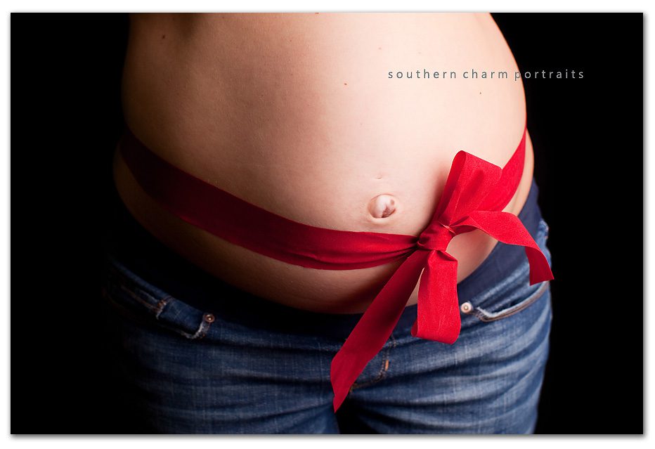 red ribbon around mother's belly.  a baby would be a wonderful Christmas gift
