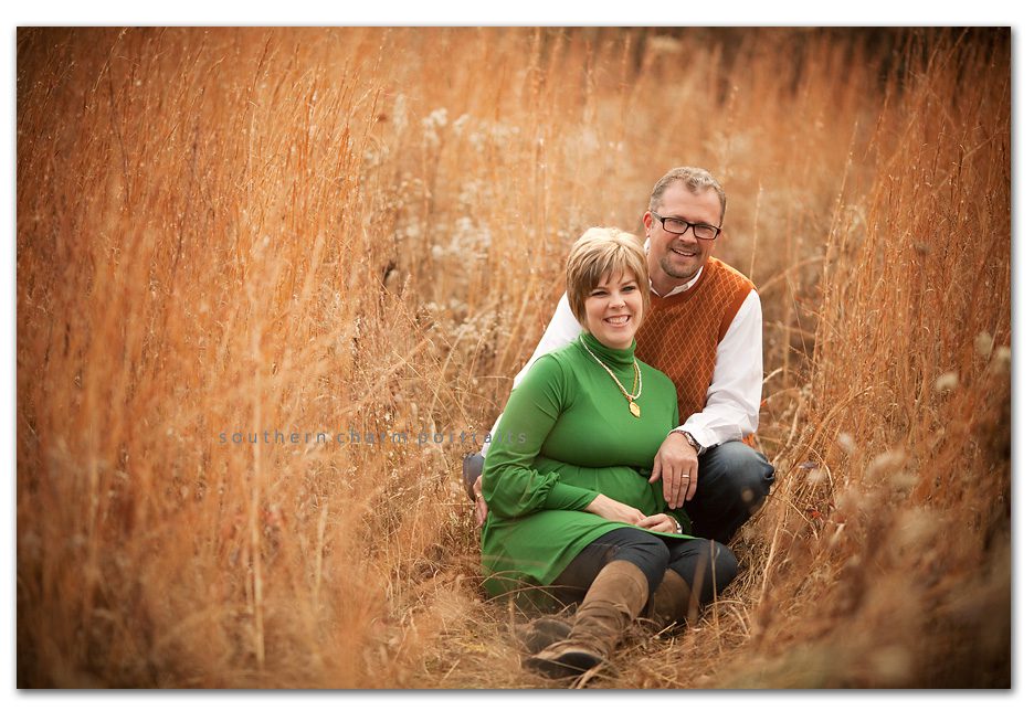 expecting parents in field fall colors and tall grass