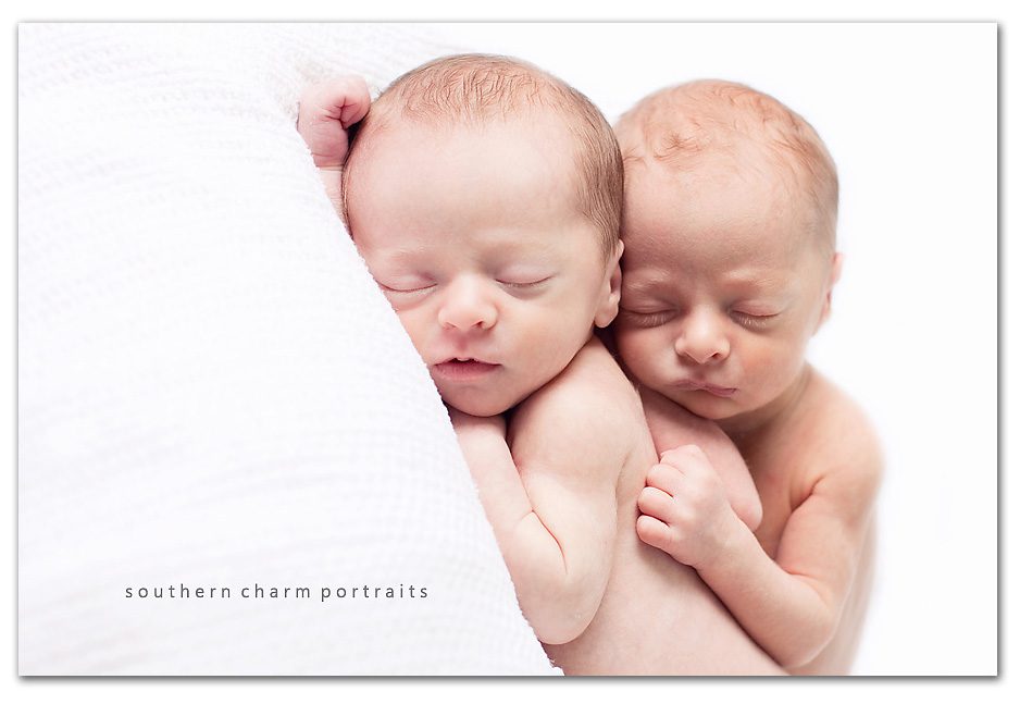 newborn twins sleeping soundly together