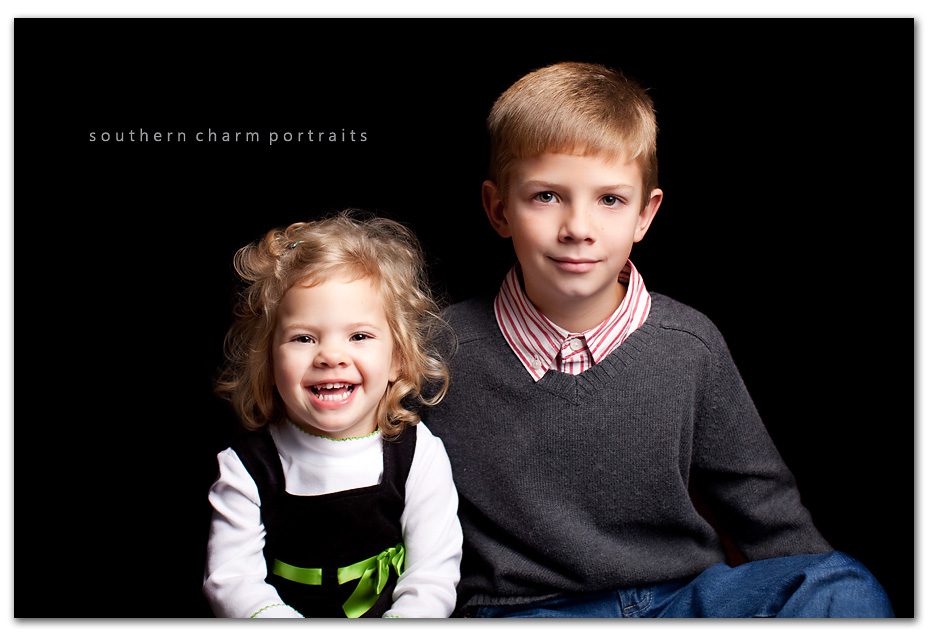 brother and sister having holiday portraits taken.  sister is obviously having a great time, but i'm not so sure about big brother