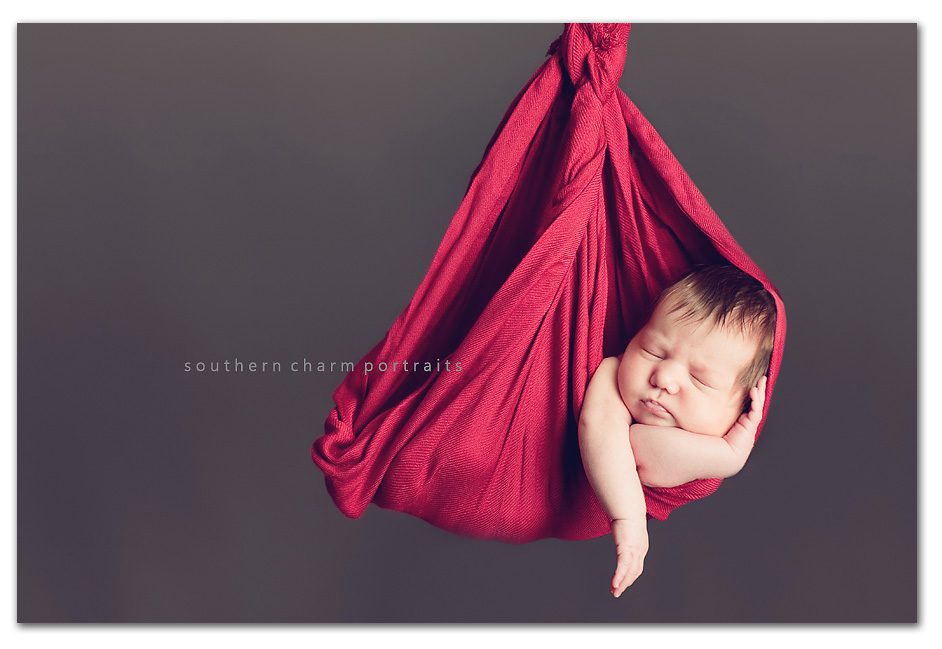 hanging baby in red sling