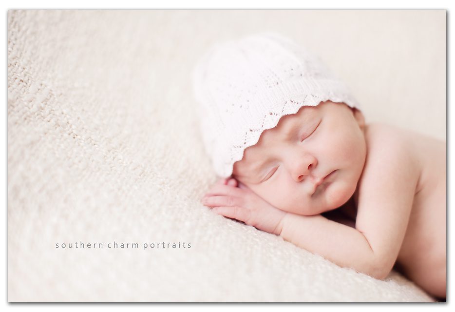 6 day old baby girl on blanket with special hat