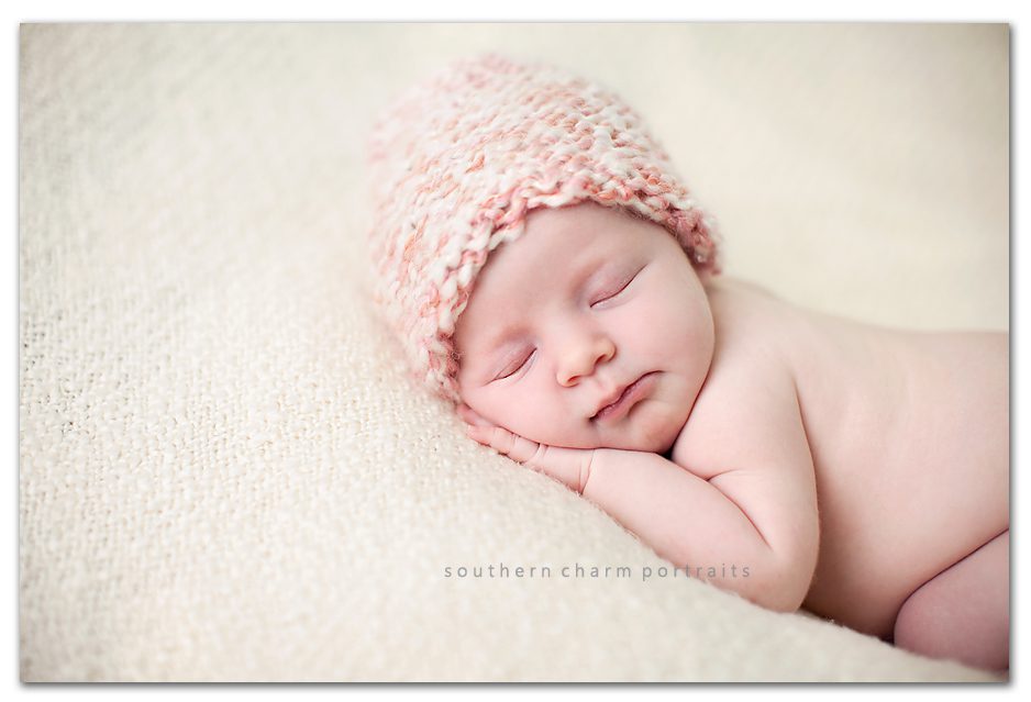 baby sleeping on target blanket with knitted pink hat