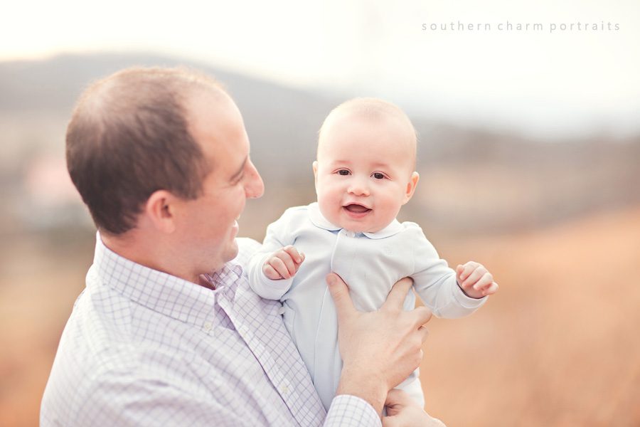 father holding baby son and smiling together, a sweet moment