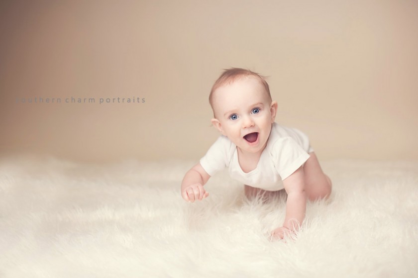 crawling baby on fur and beige backdrop in studio in lafollette, tn by photographer rebekah stanfill