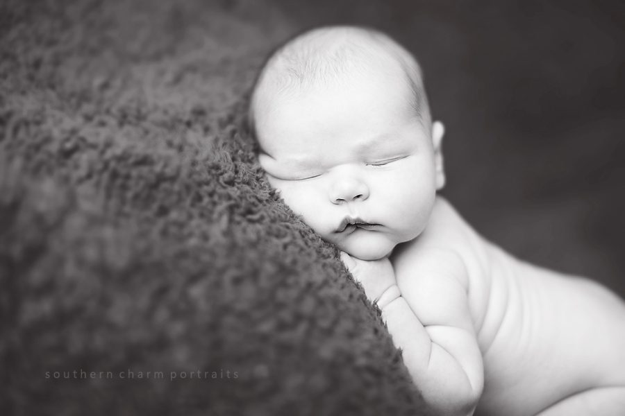 black and white image of sleeping newborn