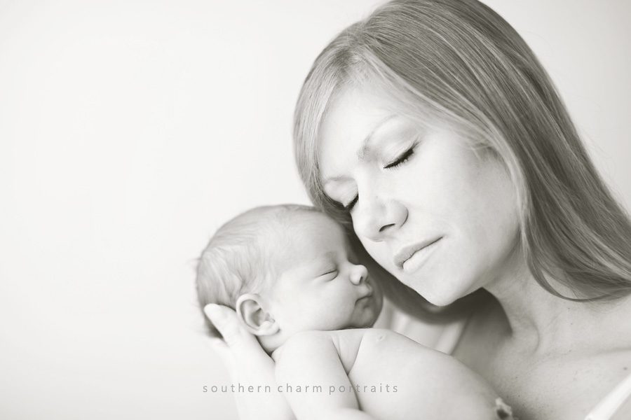 mother loving on newborn girl, black and white image