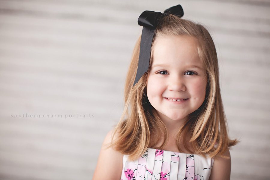 little girl with black ribbon in hair