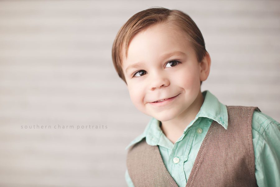  boy smiling with big brown eyes