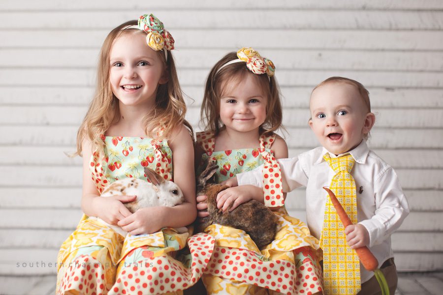 three children wearing polkadaisies knot dresses and coordinating pants, headbands, and boy's tie