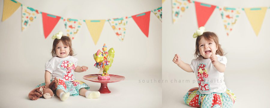 little girl with first birthday outfit and banner