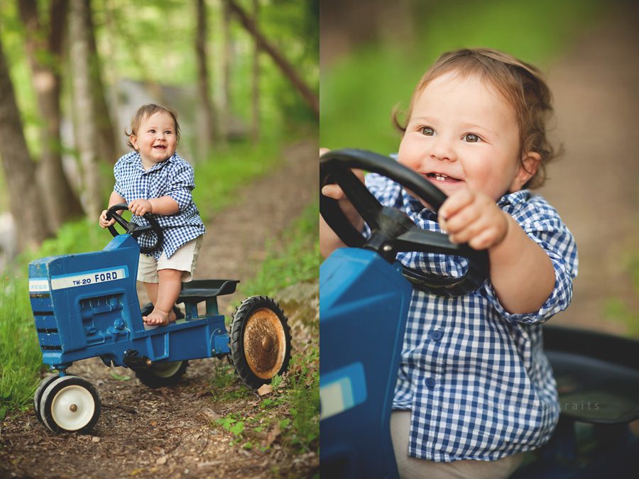 little boy standing on toy tractor outside