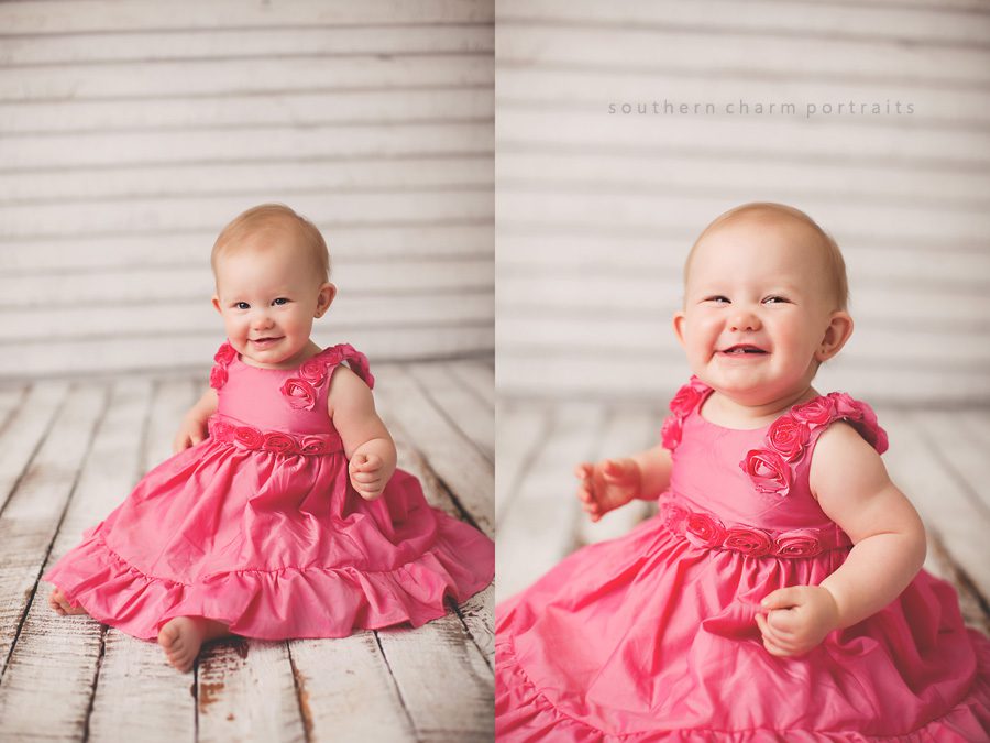 baby in local portrait studio with beautiful pink dress